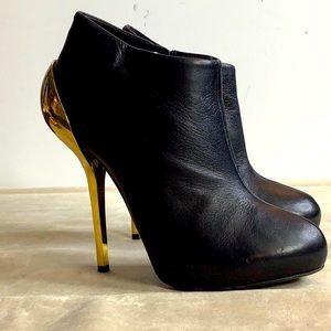 Giuseppe Zanotti black leather booties with metallic gold heels
